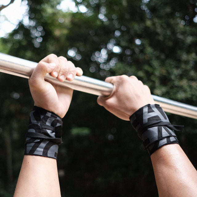 both hand grabbing bar with grav wrist wraps